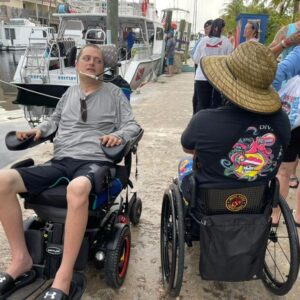 Two dive pirates in wheelchairs on the dock