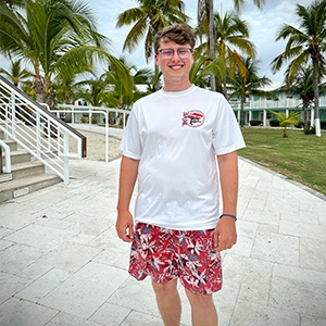 Evan in a short sleeved White Performance shirt on Cayman Brac front