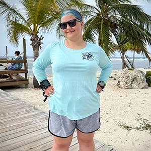 Jaclyn in blue long sleeved performance shirt on Cayman Brac front