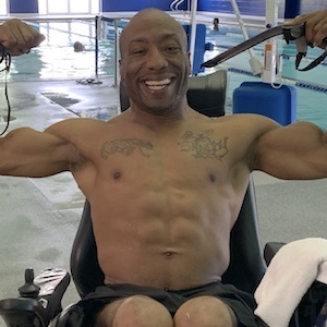 2020 Recipient Antonio Wright working out in his wheelchair in front of a swimming pool