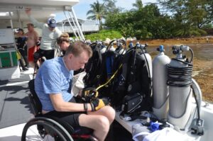 Adaptive Diver I wheelchair checking scuba tank
